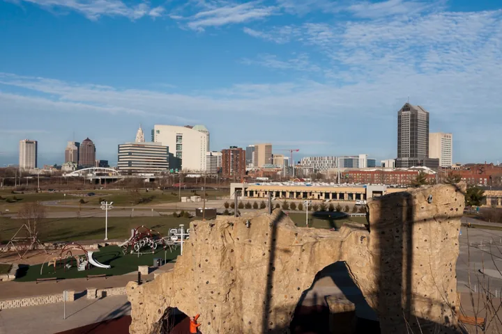 Downtown Columbus beyond the climbing wall at Scioto Audubon Metro Park