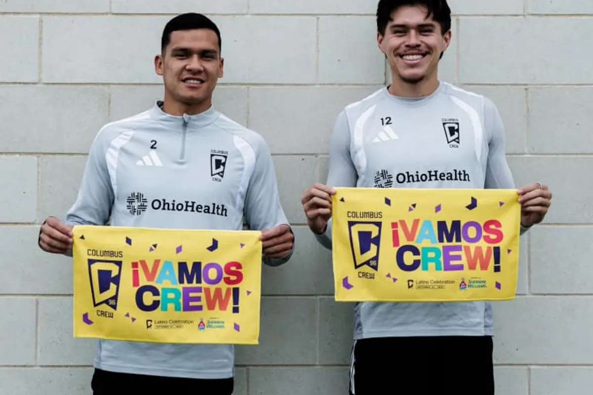 Two Crew players pose holding yellow fan towels