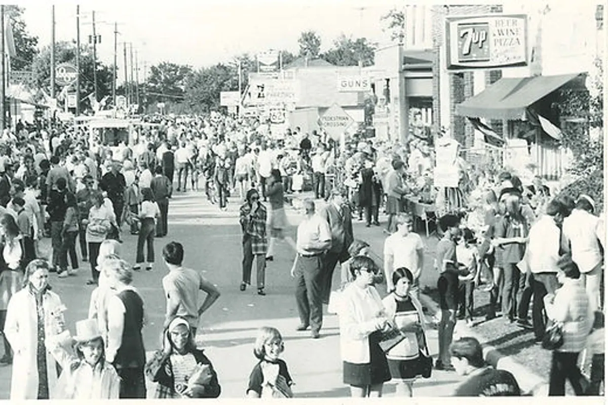 Crowded street market scene with shops and vendors