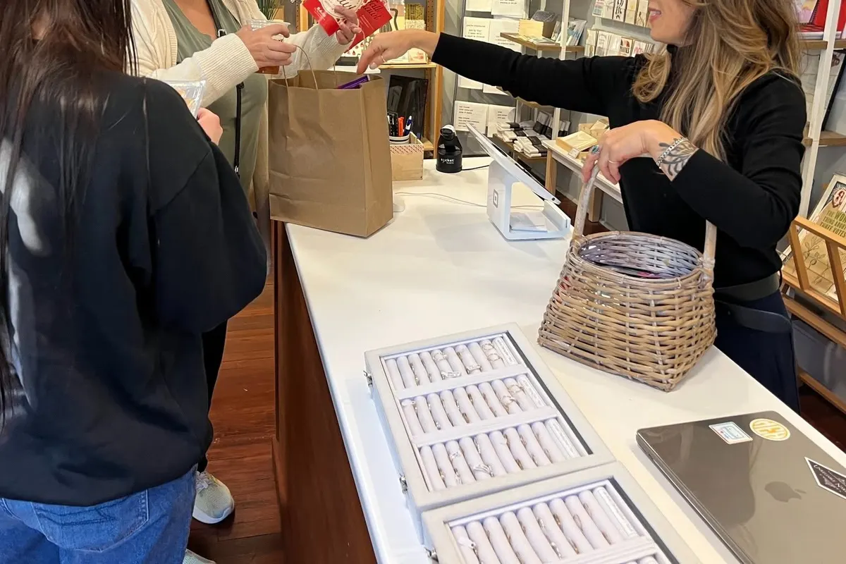 Shoppers browse a gift shop counter downtown