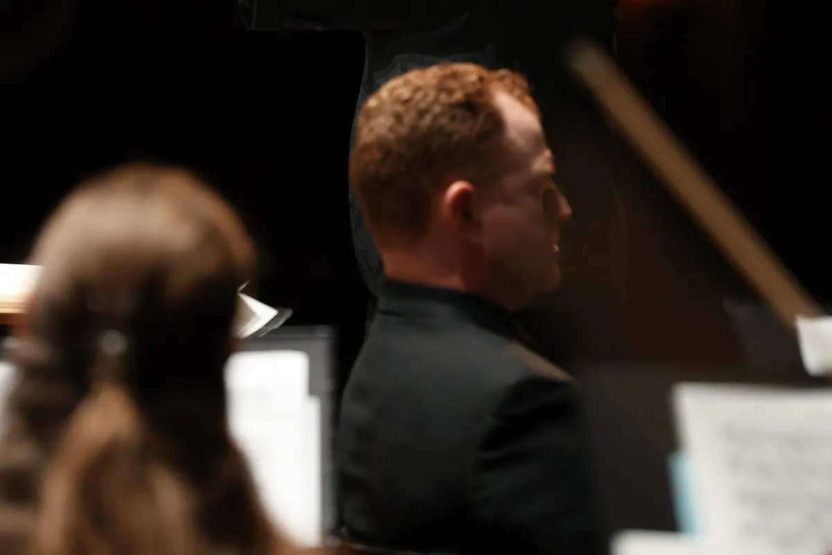 Conductor leading Columbus Symphony musicians on stage